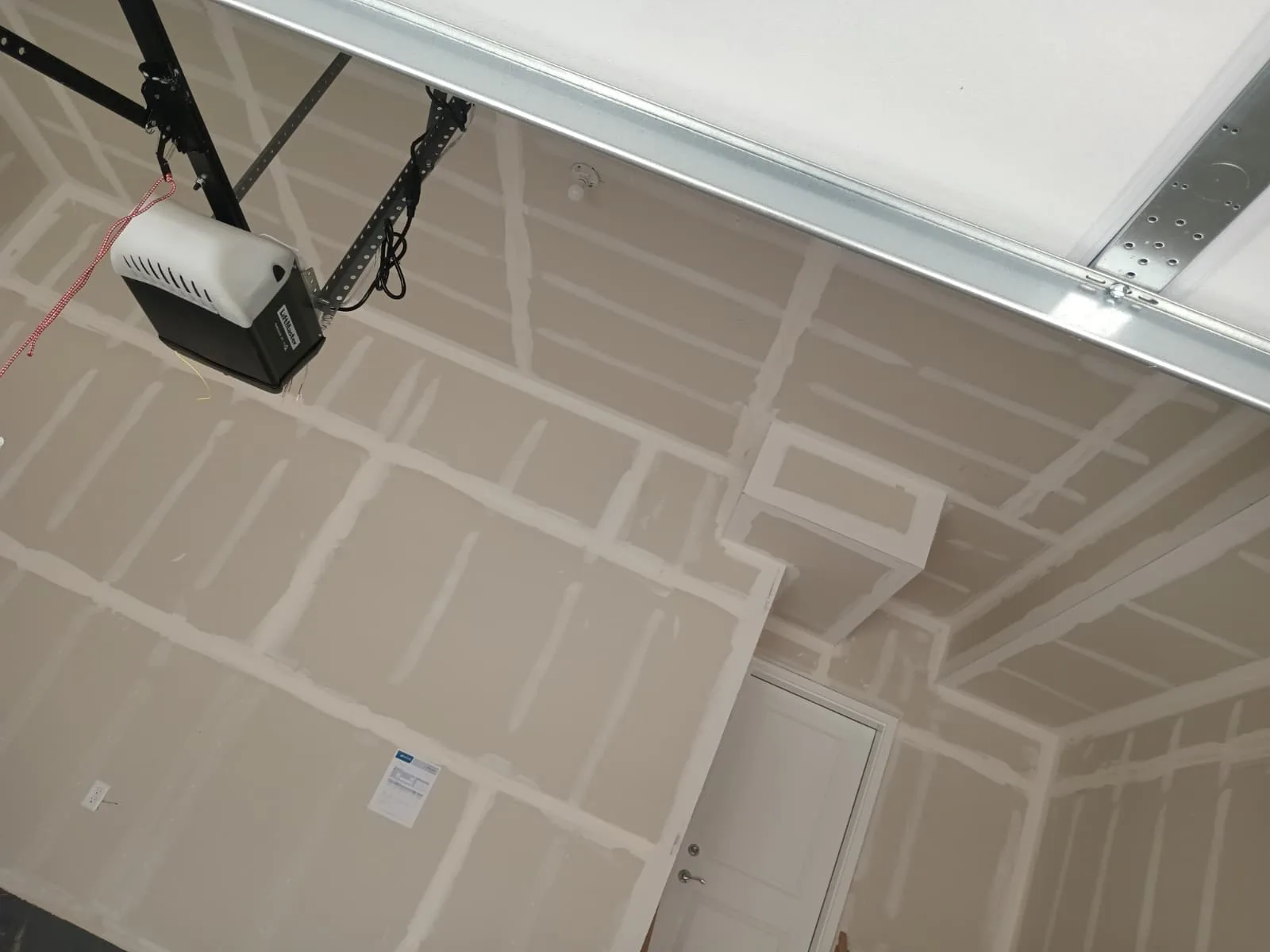 Garage hung and taped, ceiling and walls done together